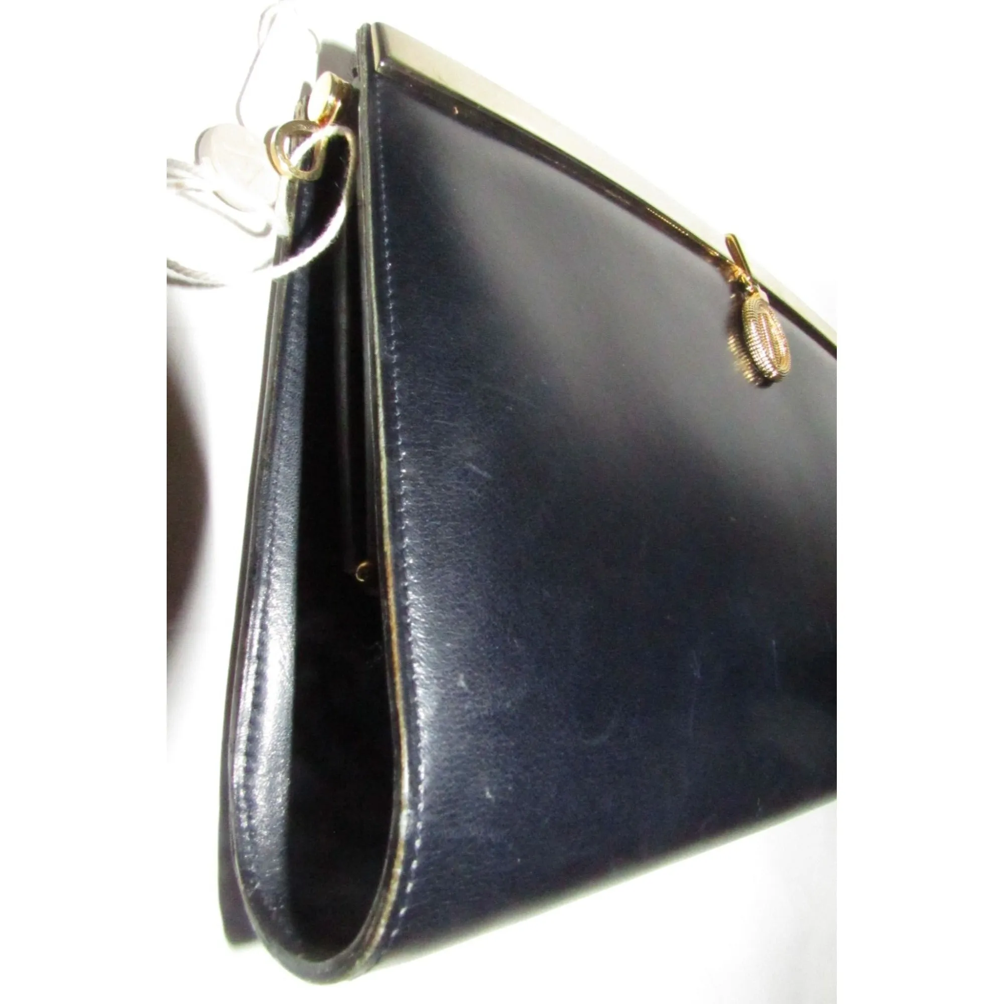1960s mod, Dior, navy blue leather, two-way style with a hinged top with a latch snap closure, bold, gold Dior accents, & a removable strap
