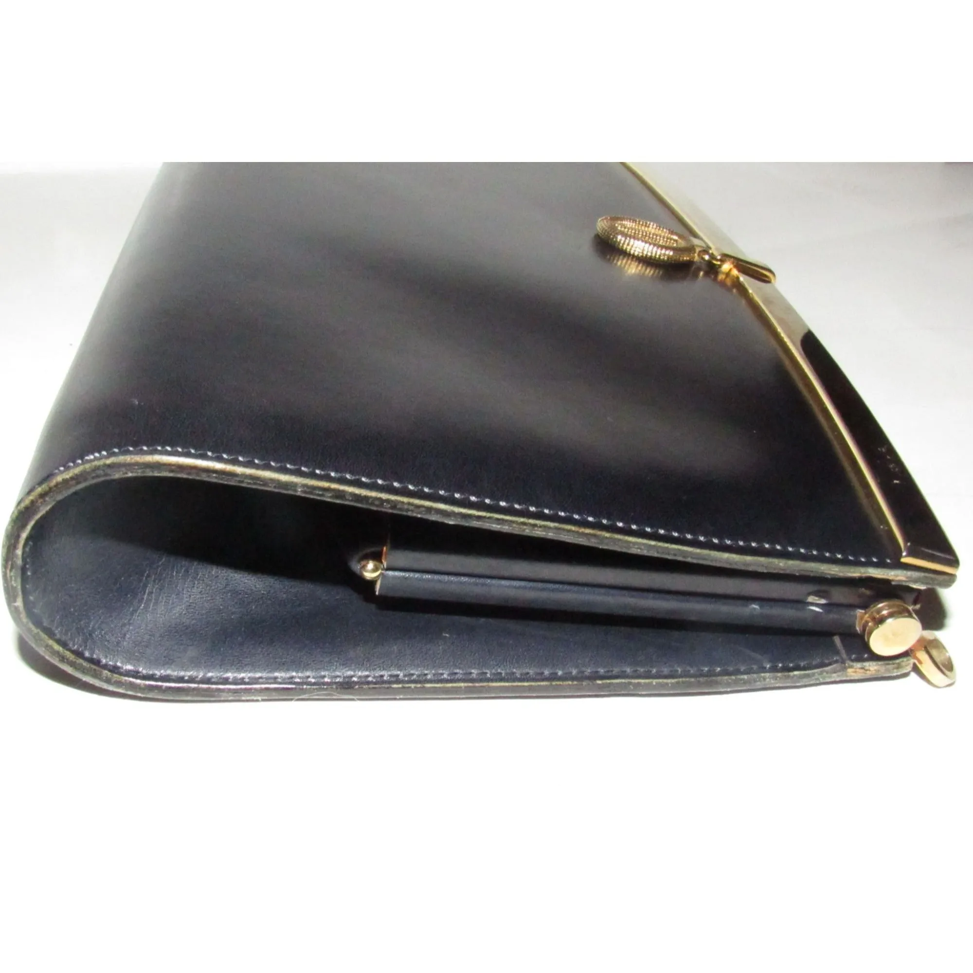 1960s mod, Dior, navy blue leather, two-way style with a hinged top with a latch snap closure, bold, gold Dior accents, & a removable strap