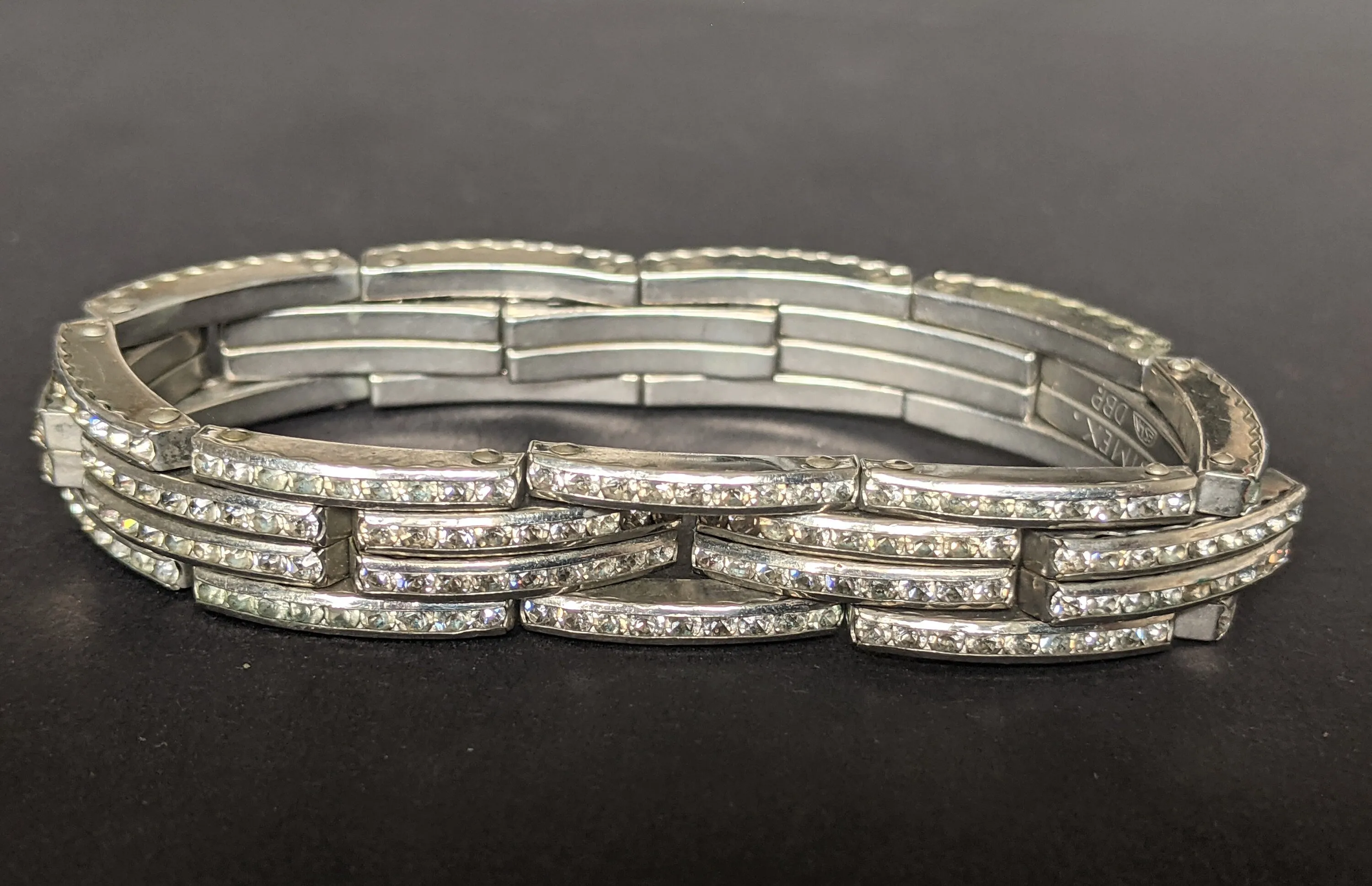 Vintage Art Deco DRGM channel set paste machine age stretch cocktail bracelet - signed 'Simex', a Schreiber & Hiller trademark